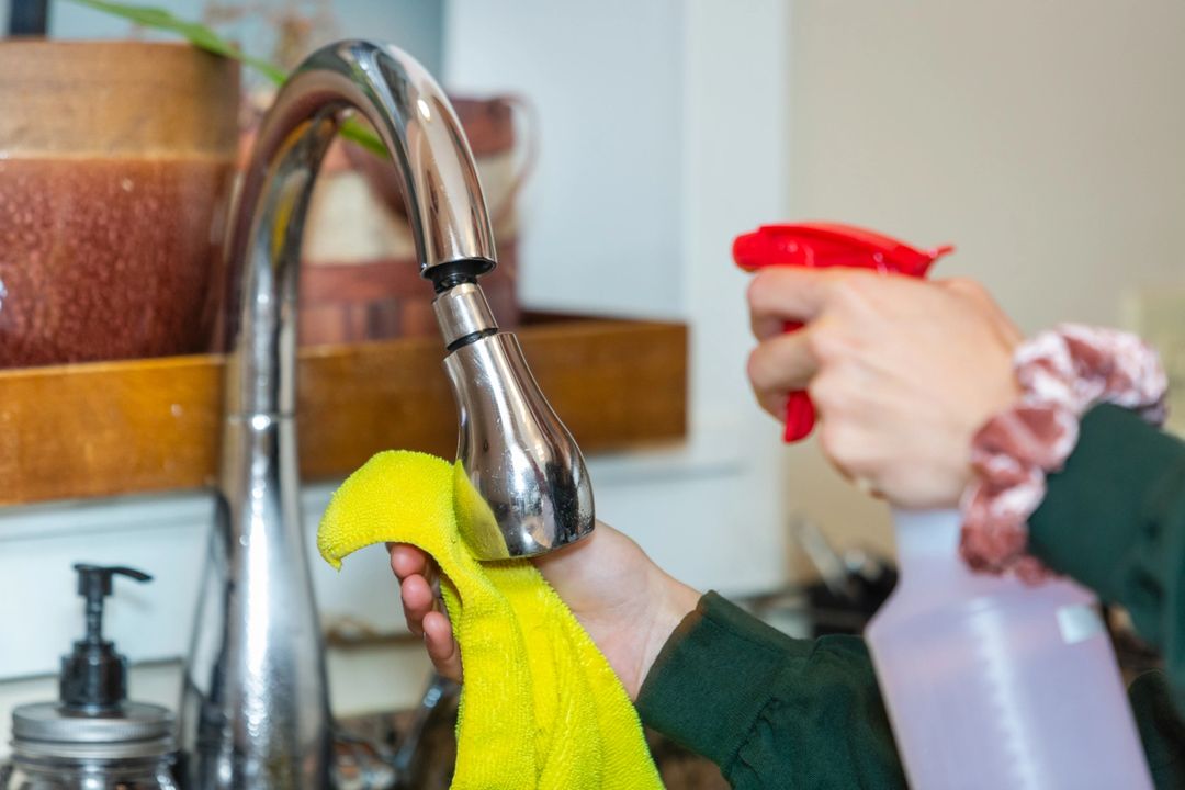 Cleaning Tap With Disinfectant Spray